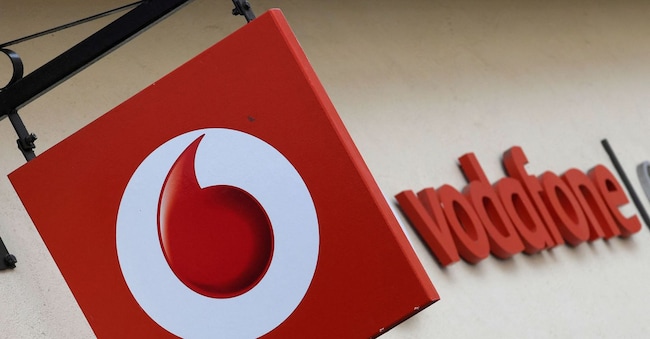FILE PHOTO: Branding hangs outside a Vodafone shop in Oxford, Britain, May 16, 2017. REUTERS/Toby Melville/File Photo REUTERS