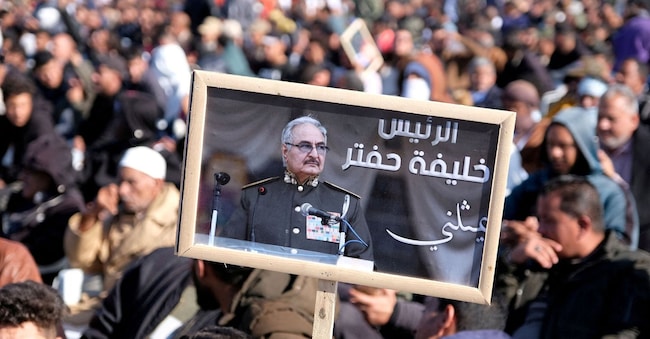FILE PHOTO: A man holds a picture of commander Khalifa Haftar during Independence Day celebrations in Benghazi, Libya December 24, 2022. REUTERS/Stringer/File Photo REUTERS
