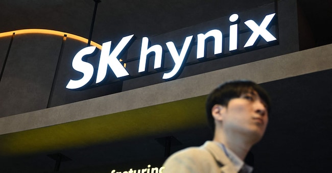 A visitor walks past the logo of SK hynix during the Korea Electronics Show 2025 at the COEX convention and exhibition centre in Seoul on October 22, 2025. (Photo by Jung Yeon-je / AFP) AFP