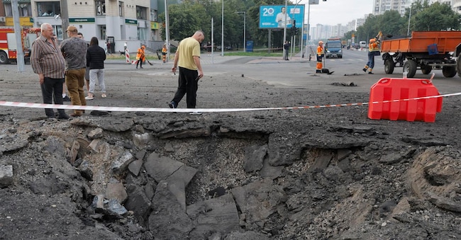 Alcune persone osservano un cratere in una strada dopo un attacco missilistico russo contro una zona residenziale di Kiev, in Ucraina, l’11 luglio 2026, nel corso dell’invasione russa. Secondo il Servizio statale di emergenza, almeno 10 persone, tra cui un bambino di 11 anni, sono rimaste ferite nel corso di un massiccio attacco combinato russo sferrato durante la notte contro Kiev. EPA/SERGEY DOLZHENKO EPA