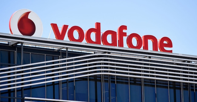 (FILES) A picture taken on on July 28, 2015 shows the logo of British telecom giant Vodafone atop the Spanish headquarters in Madrid. After its acquisition last month by an investment fund, Vodafone Spain on June 12, 2024 said it was planning to axe almost 1,200 staff, more than a third of its workforce. (Photo by GERARD JULIEN / AFP) AFP