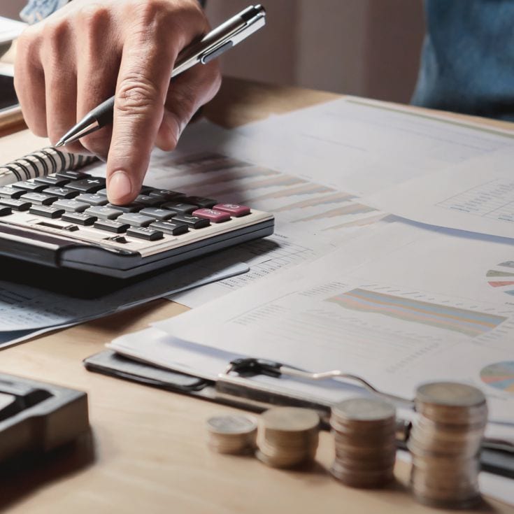 businessman working in office with using a calculator to calculate the numbers finance accounting concept lovelyday12 - stock.adobe.com