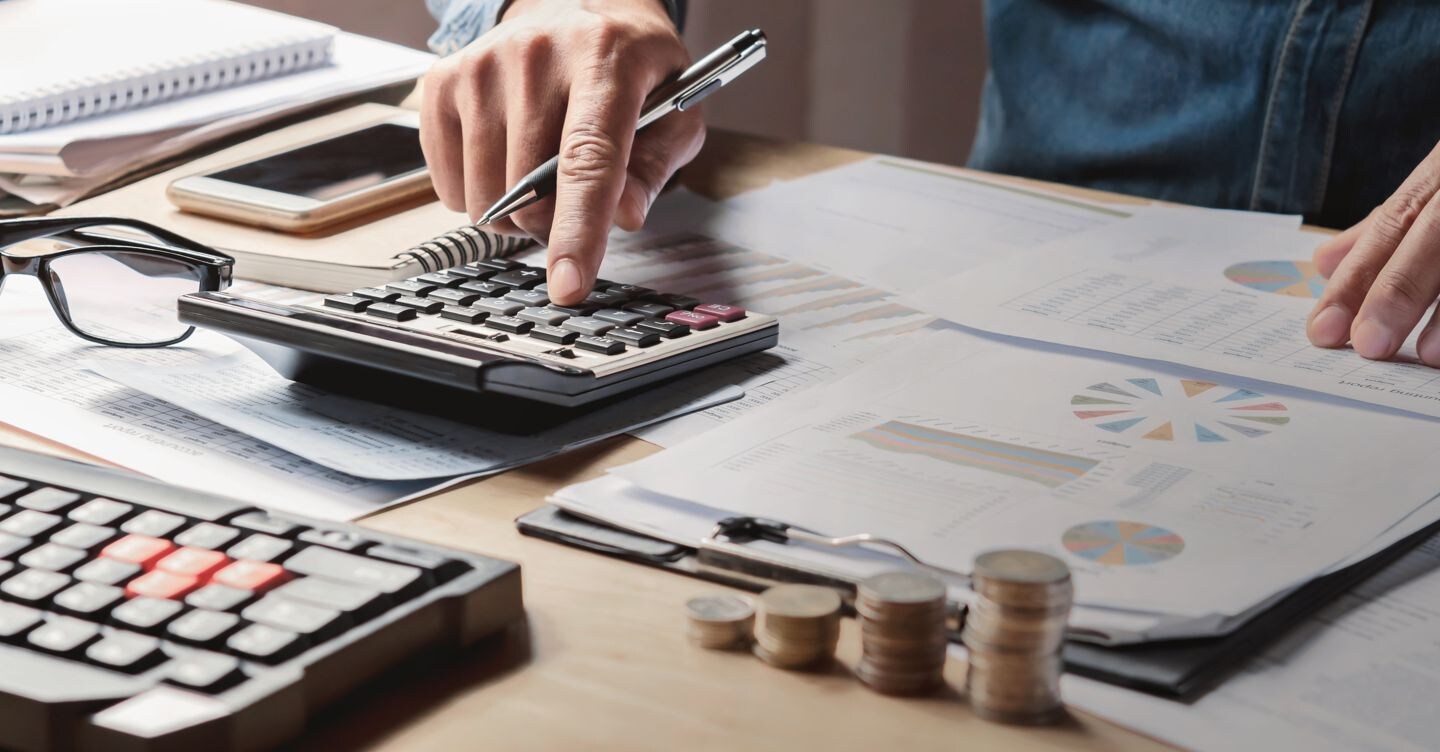 businessman working in office with using a calculator to calculate the numbers finance accounting concept lovelyday12 - stock.adobe.com