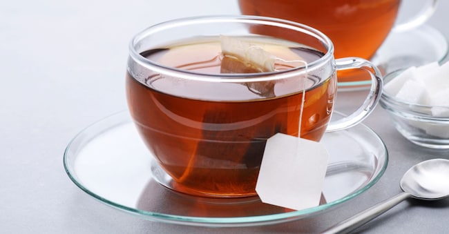 Cup of tea with tea bag on a gray background. vitals - stock.adobe.com