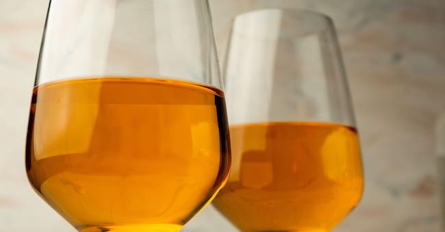 2AGEY21 tall glass of rich orange wine Alamy Stock Photo