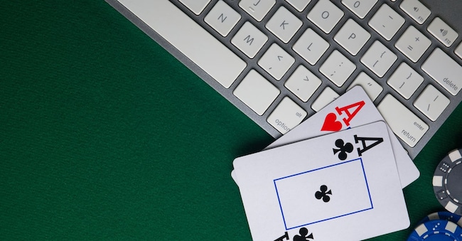 Poker online, casino, online gaming business. Chips, money cards and pc. Anton - stock.adobe.com