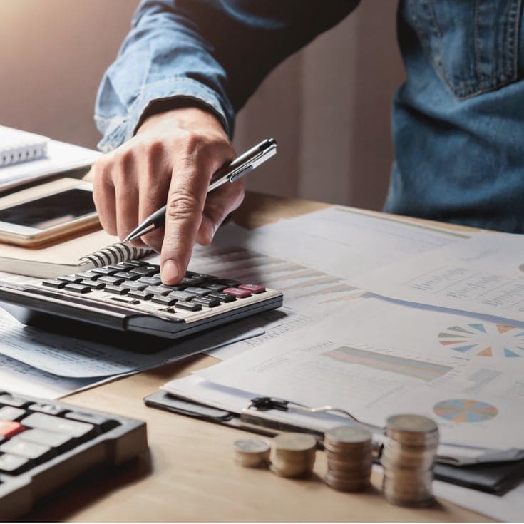 businessman working in office with using a calculator to calculate the numbers finance accounting concept lovelyday12 - stock.adobe.com
