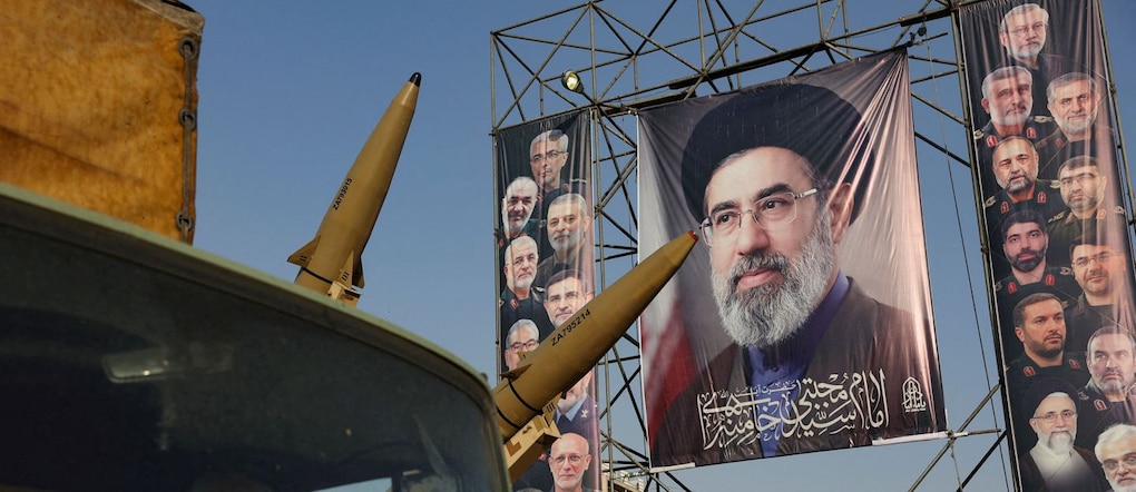 Missili iraniani schierati per propaganda a Teheran vicino a un poster della Guida Suprema Mojtaba Khamenei via REUTERS