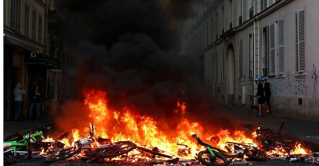 FILE PHOTO: Bicycles burn during civil unrest, the day after a national day of demonstrations against the cost of living and rising fuel prices, in Paris, France, October 18, 2026. REUTERS/Abdul Saboor/File Photo REUTERS
