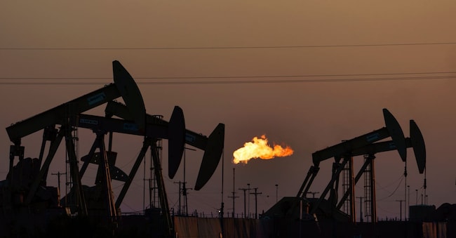 FILE - A flare burns off methane and other hydrocarbons as oil pumpjacks operate in the Permian Basin in Midland, Texas, on Oct. 12, 2021. (AP Photo/David Goldman, File) APN