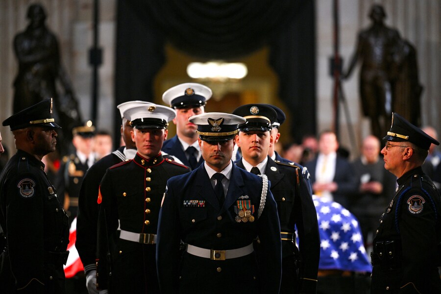 I membri della Guardia d’onore escono dall’area in cui si trova la bara avvolta dalla bandiera del presidente degli Stati Uniti Jimmy Carter, mentre giace nella Rotonda del Campidoglio degli Stati Uniti a Washington. (REUTERS)