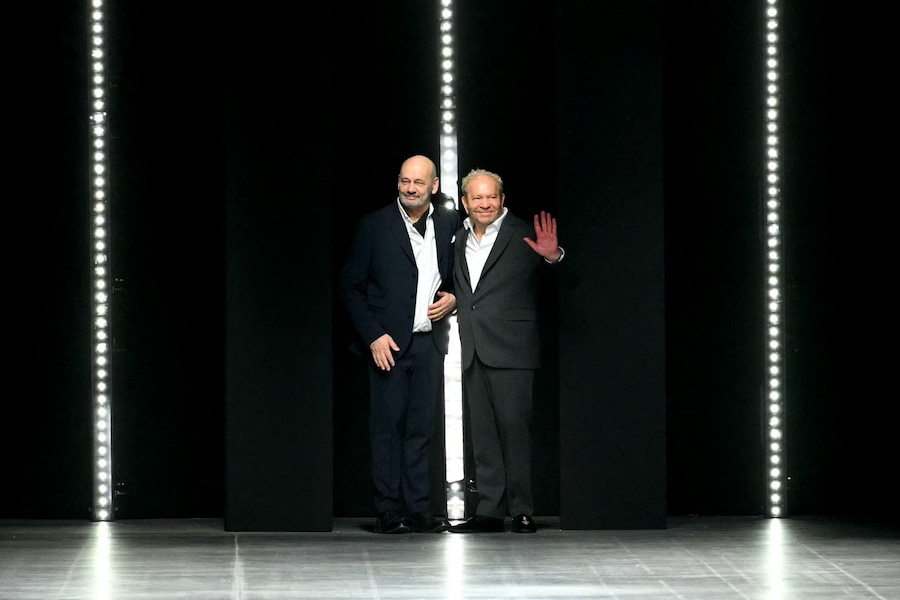 Italian entrepreneur Toni Scervino (L) and designer Ermanno Daelli (R) acknowledge the audience at the end of Ermanno Scervino's fashion show as part of the Womenswear Autumn-Winter 2025 Milan Fashion Week in Milan on March 1, 2025. (Photo by Andreas SOLARO / AFP) (AFP)