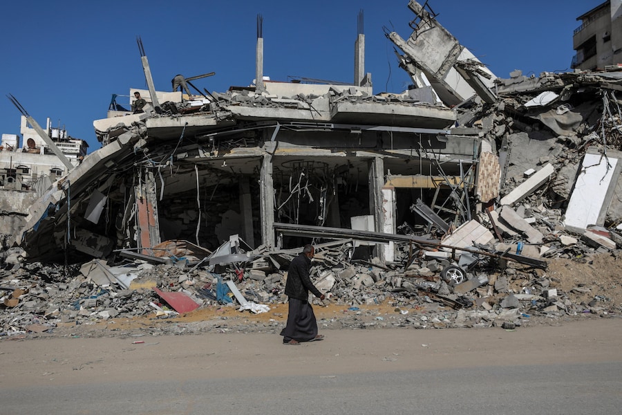 Un anziano palestinese passa davanti a un edificio distrutto a Gaza City, nel nord della Striscia di Gaza. (EPA)