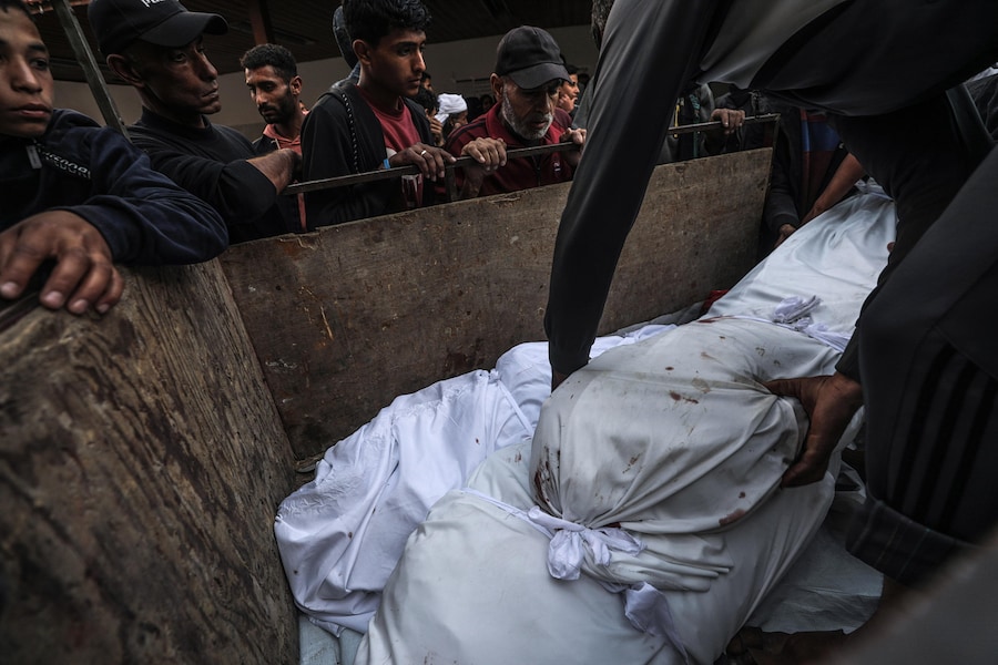 Persone trasportano i corpi coperti di quattro giovani palestinesi uccisi a seguito di un attacco aereo israeliano nel quartiere di Al Zaytoun, a est di Gaza City. (EPA)