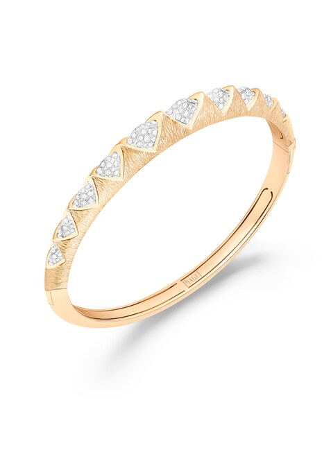 Piaget. Bracciale in oro rigato con intarsi in pavé di diamanti che ne ridisegnano il volume, collezione Sunlight