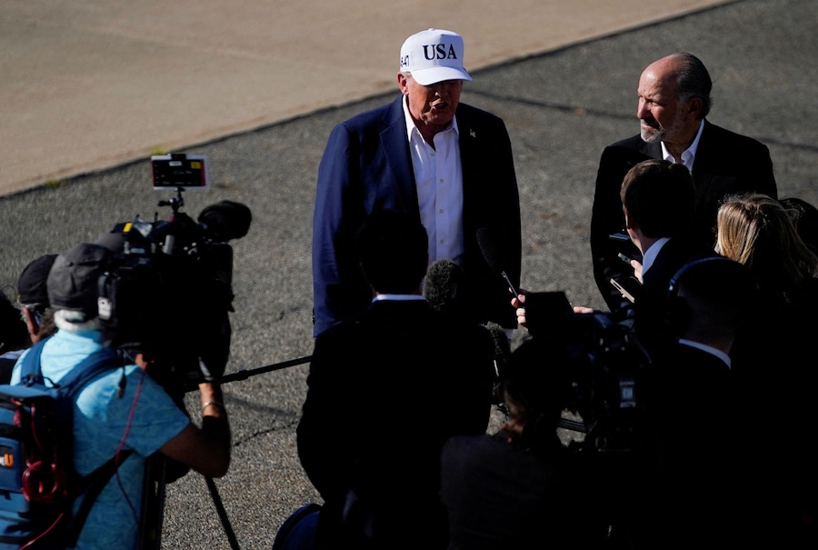 Il presidente degli Stati Uniti Donald Trump in piedi accanto al segretario al commercio degli Stati Uniti Howard Lutnick, mentre parla con i media, al suo arrivo all’aeroporto di Morristown, a Morristown, New Jersey, Stati Uniti, 6 luglio 2025. (REUTERS)