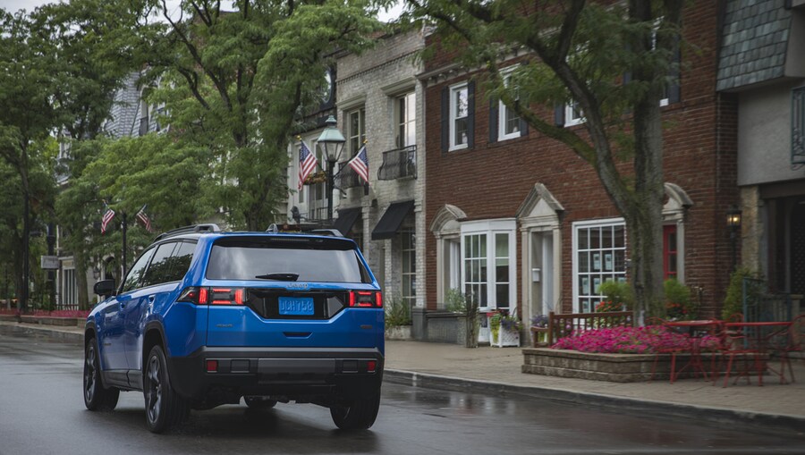 A rear view of the 2026 Jeep® Cherokee Overland on a city street (© 2025 Stellantis)