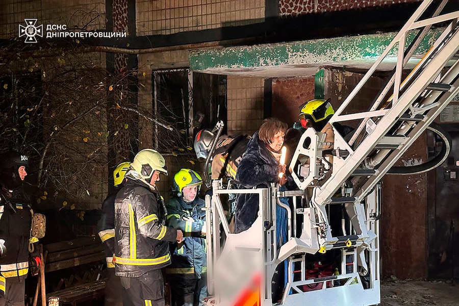 I vigili del fuoco evacuano un residente in seguito a un attacco missilistico russo che ha colpito un condominio a più piani a Dnipro, in Ucraina (APN)