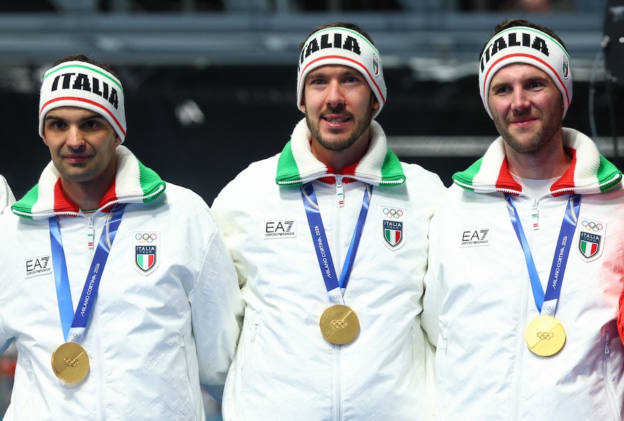 Olimpiadi Milano Cortina 2026 - Pattinaggio di velocità - Cerimonia di premiazione dell'inseguimento a squadre maschile - Stadio del pattinaggio di velocità di Milano, Milano, Italia - 17 febbraio 2026. I medagliati d'oro Davide Ghiotto (Italia), Michele Malfatti (Italia) e Andrea Giovannini (Italia) festeggiano sul podio dopo aver vinto l'inseguimento a squadre maschile. (REUTERS/Yves Herman)