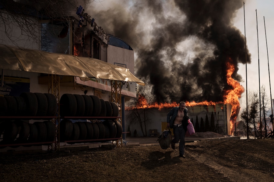 Un uomo recupera alcuni oggetti da un negozio che ha preso fuoco durante un attacco russo a Kharkiv, in Ucraina, venerdì 25 marzo 2022. (foto di archivio) (AP Photo/Felipe Dana/Associated Press/ LaPresse/APN)