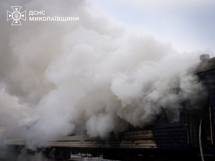 Il fumo si alza da un treno passeggeri dopo essere stato colpito da un drone russo in una stazione ferroviaria nella regione di Mykolaiv, Ucraina (via REUTERS)