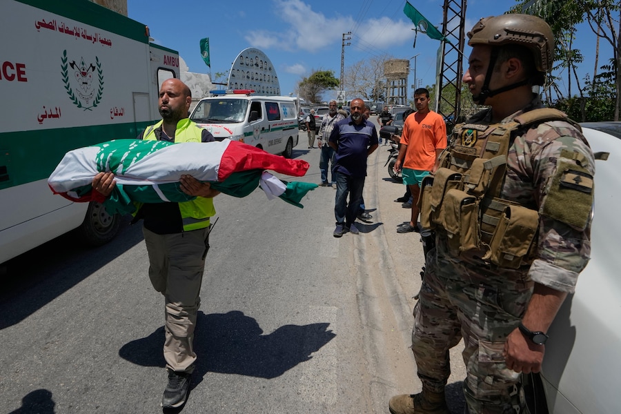 Un paramedico volontario trasporta una salma, una delle sei vittime della stessa famiglia uccise mercoledì quando la loro auto è stata colpita da un attacco aereo israeliano su un'autostrada mentre fuggivano dal loro villaggio. (APN)
