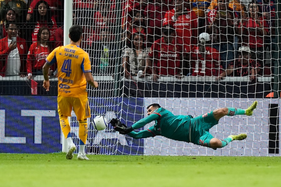 Toluca's goalkeeper Luis Garcia, right, blocks a shot by Tigres' Juan Purata during a penalty shootout on the CONCACAF Champions Cup final soccer match in Toluca, Mexico, Saturday, May 30, 2026. (AP Photo/Fernando Llano) (AP Photo/Fernando Llano)