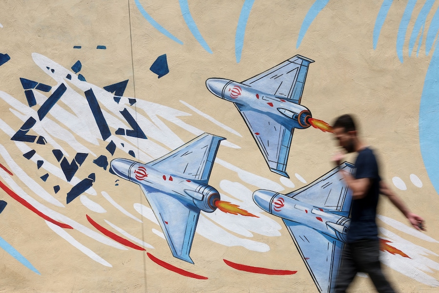 Un uomo iraniano cammina accanto a un murale anti-israeliano in una strada di Teheran, in Iran. (via REUTERS)