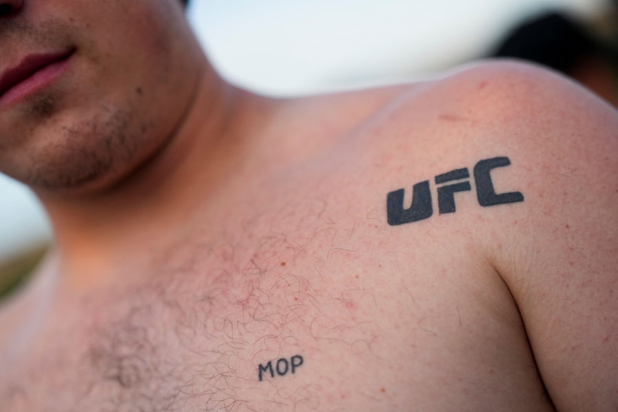 Un tifoso con un tatuaggio "UFC" al Fan Fest in occasione della pesatura ufficiale dei lottatori partecipanti all'UFC Freedom 250, presso l'Ellisse vicino alla Casa Bianca, a Washington, D.C., Stati Uniti, il 13 giugno 2026. REUTERS/Nathan Howard (REUTERS)