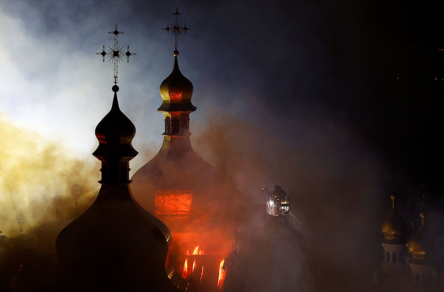 I vigili del fuoco lavorano presso la Cattedrale della Dormizione del monastero di Pechersk Lavra di Kiev, in fiamme dopo essere stata colpita da missili e droni russi, a Kiev, Ucraina (REUTERS)