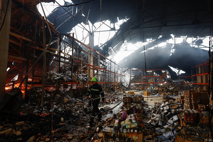 Un pompiere interviene sul luogo in cui si trovano i magazzini di generi alimentari e bevande colpiti durante la notte da un attacco missilistico russo, nel contesto dell’offensiva russa contro l’Ucraina, a Kiev, Ucraina. (REUTERS)