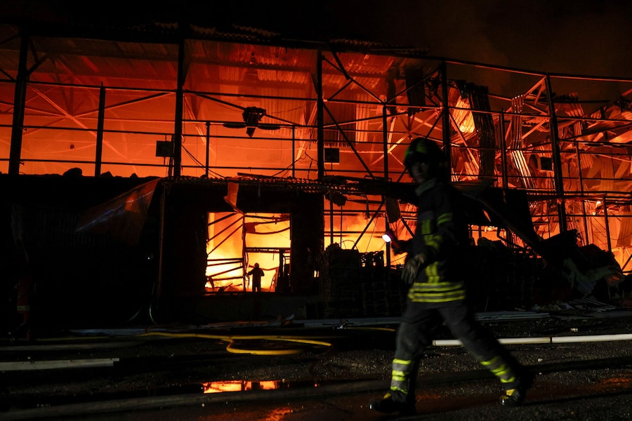 I vigili del fuoco intervengono in un complesso di magazzini danneggiato durante gli attacchi missilistici russi, nel contesto dell'offensiva russa contro l'Ucraina, a Kiev. (REUTERS)