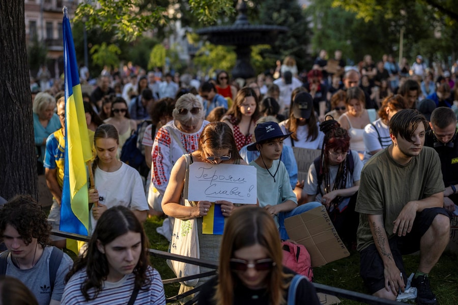 La gente osserva un minuto di silenzio durante una manifestazione di protesta contro la decisione del presidente ucraino Volodymyr Zelenskiy di sostituire Mykhailo Fedorov alla carica di ministro della Difesa, mentre la Russia continua ad attaccare l’Ucraina, a Kiev, Ucraina, il 16 luglio 2026. (REUTERS)