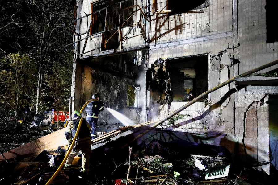 Vigili del fuoco al lavoro sul luogo di un condominio colpito da un attacco missilistico russo a Kiev (REUTERS)
