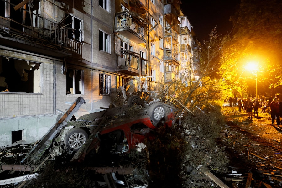 Un veicolo danneggiato presso un condominio colpito da un attacco missilistico russo a Kiev (REUTERS)