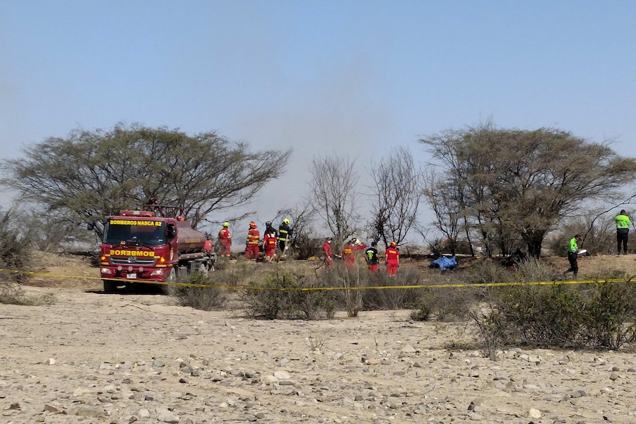 epa13146564 Members of the Nazca Fire Department work in the area where a small plane flying over the Nazca Lines crashed, killing at least 13 people, including 11 tourists, in the provincial municipality of Nazca, Peru, 01 August 2026. EPA/Victor Quilca BEST QUALITY AVAILABLE (EPA)