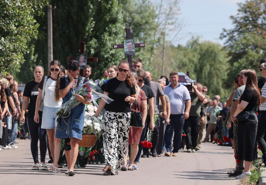I partecipanti al funerale rendono omaggio ai membri della famiglia Voronov, uccisi da un attacco con un missile balistico russo contro la loro abitazione nel villaggio di Radushne, alla periferia di Kryvyi Rih, nella regione di Dnipropetrovsk. (EPA)