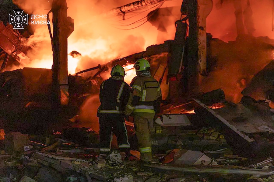 Una foto fornita dal Servizio statale di emergenza mostra i soccorritori ucraini al lavoro sul luogo di un attacco con missili balistici russi contro una zona residenziale di Kiev, in Ucraina (EPA)