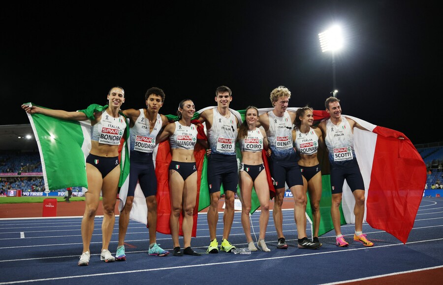 Campionati europei di atletica leggera - Alexander Stadium, Birmingham, Gran Bretagna - 16 agosto 2026 L'italiano Edoardo Scotti, Luca Sito, Mohamed Soudassi e Lorenzo Benati festeggiano dopo aver vinto la medaglia d'oro nella staffetta 4x400 m maschile insieme alle medaglie di bronzo della staffetta 4x400 m femminile, le italiane Alessandra Bonora, Anna Polinari, Alice Mangione ed Eloisa Coiro. (REUTERS/Andrew Boyers)