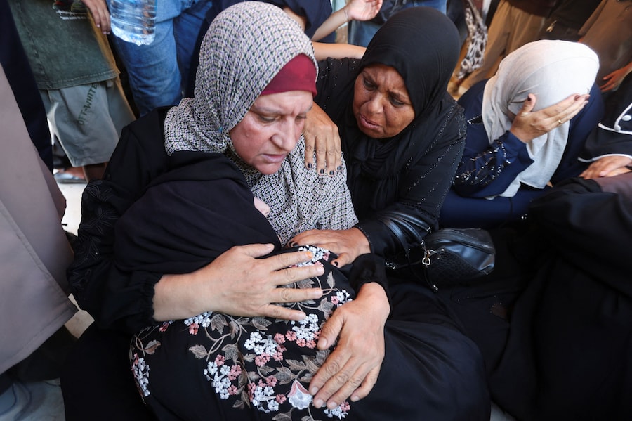 I partecipanti al funerale reagiscono durante la cerimonia funebre di Huthaifa Kawari, un uomo palestinese ucciso, secondo quanto riferito dal personale medico, in un attacco israeliano all’ospedale Nasser di Khan Younis, nella Striscia di Gaza meridionale, il 13 agosto 2026. REUTERS/Ramadan Abed (REUTERS)