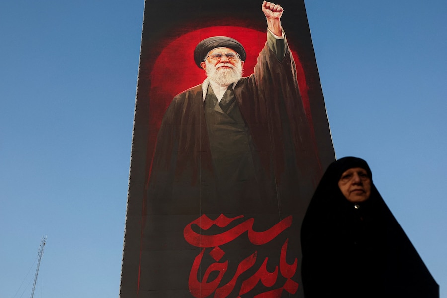 Una donna cammina vicino a un cartellone pubblicitario raffigurante il defunto leader supremo iraniano, l'ayatollah Ali Khamenei, in una strada di Teheran, in Iran, il 13 agosto 2026. Majid Asgaripour/WANA (West Asia News Agency) via REUTERS (via REUTERS)
