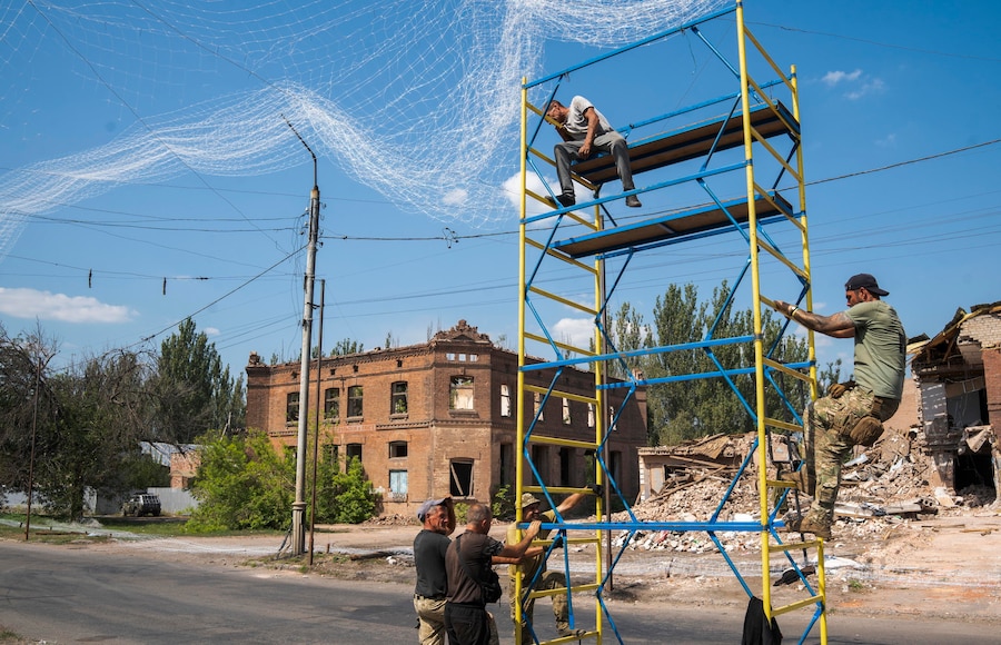 Militari ucraini del 1221° Battaglione di supporto autonomo riparano le reti anti-drone danneggiate dai recenti attacchi russi, che hanno visto l’impiego di numerose bombe aeree guidate KAB, contro una struttura a Sloviansk, nella regione di Donetsk, in Ucraina. (EPA)
