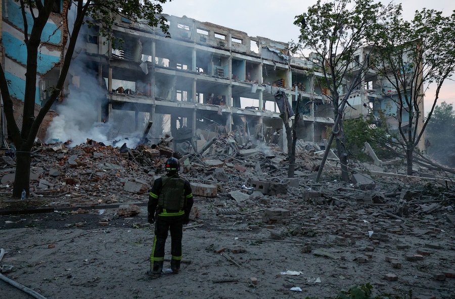 Un pompiere si trova davanti a un edificio distrutto a seguito di un attacco ucraino, nel corso del conflitto tra Russia e Ucraina a Donetsk, una città ucraina sotto il controllo russo. (REUTERS/Alexander Ermochenko)