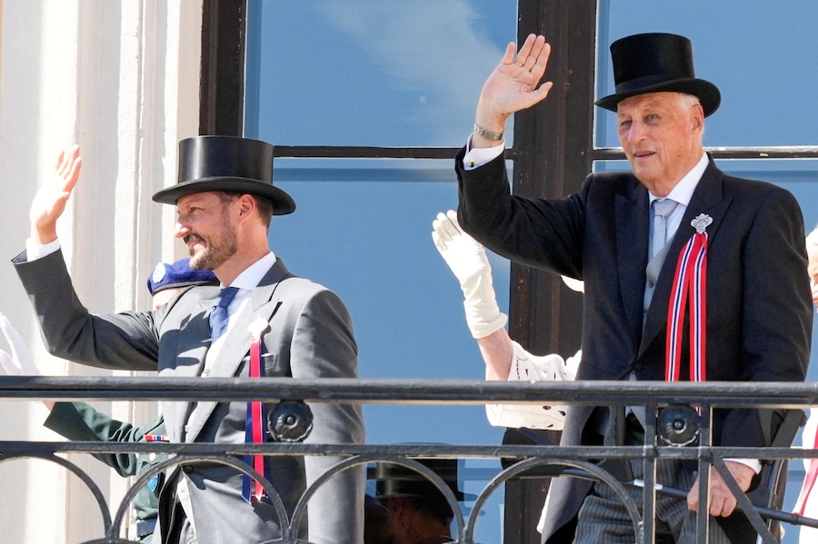 Il re Harald di Norvegia e il principe ereditario Haakon salutano il corteo dei bambini dal balcone del Palazzo Reale a Oslo.NTB/Heiko Junge/via REUTERS (via REUTERS)