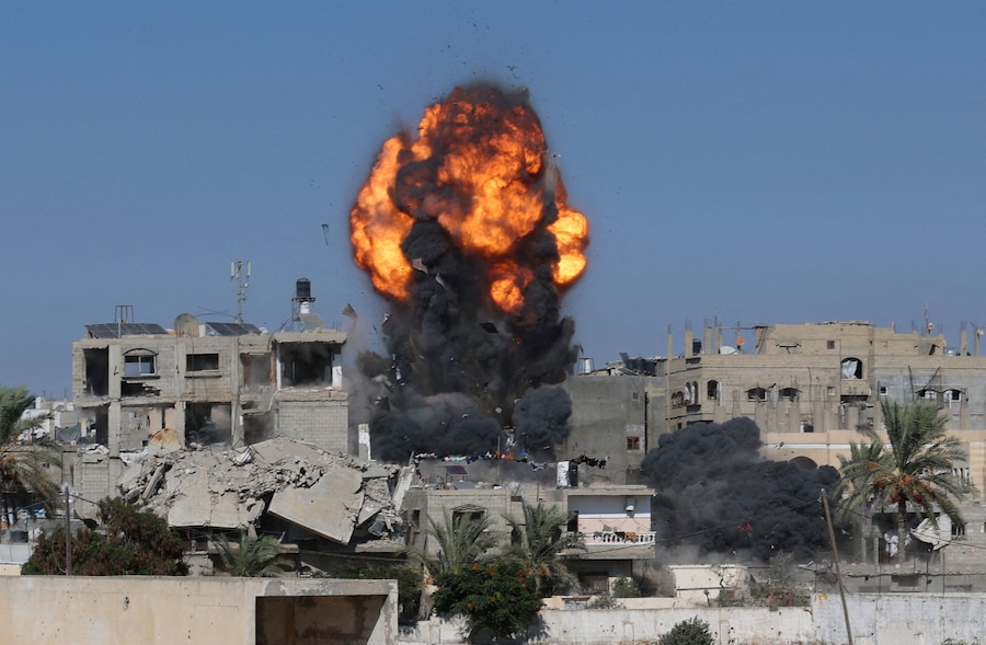 Fumo e fiamme si levano da un’abitazione durante un attacco israeliano, sferrato dopo che l’esercito israeliano aveva intimato ai residenti di evacuare la zona, a Khan Younis, nella Striscia di Gaza meridionale (REUTERS)