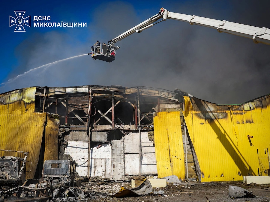I vigili del fuoco intervengono sul luogo di un magazzino colpito durante gli attacchi aerei e con droni russi a Mykolaiv, Ucraina (via REUTERS)