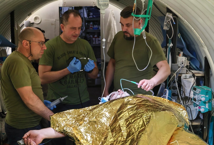Una foto fornita dall’ufficio stampa della 65ª Brigata Meccanizzata delle Forze Armate ucraine mostra i medici militari mentre prestano soccorso a un soldato ferito presso il punto di stabilizzazione medica della brigata, vicino alla linea del fronte, nella regione di Zaporizhzhia, Ucraina, il 12 settembre 2026, nel corso dell’invasione russa in corso. EPA/SERVIZIO STAMPA DELLA 65ª BRIGATA MECCANIZZATA (EPA)