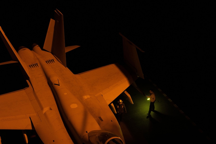 I marinai della Marina degli Stati Uniti si occupano di un jet da combattimento sul ponte di volo della USS George Washington nel Mar Arabico. (REUTERS)