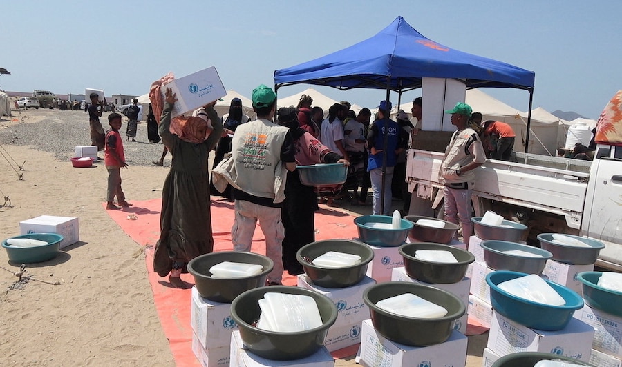 Persone sfuggite ai combattimenti tra gli Houthi e le forze governative nelle zone costiere del Mar Rosso tengono in mano generi alimentari ricevuti in un campo per sfollati interni vicino ad Aden, nello Yemen. (REUTERS/Stringer)