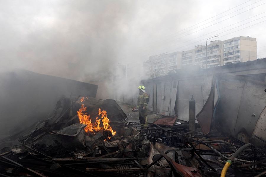 Un vigile del fuoco interviene sul luogo dell'impatto dove un'esplosione ha incendiato alcuni garage durante gli attacchi con droni russi, nel contesto dell'offensiva russa contro l'Ucraina, in un quartiere residenziale di Kiev. (REUTERS)